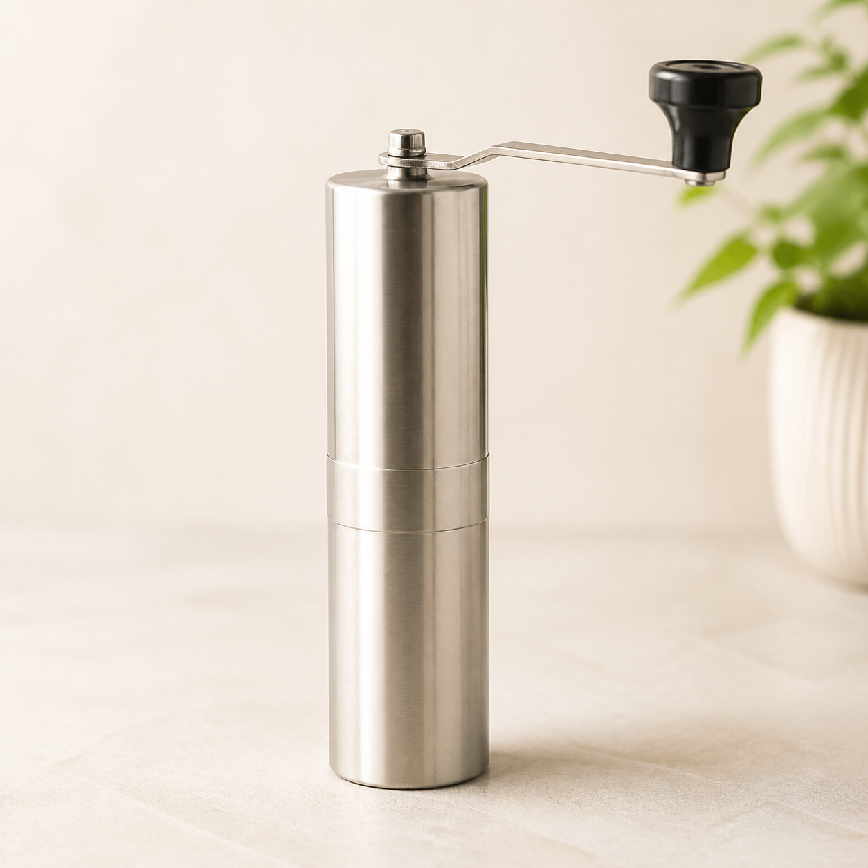 Slim stainless steel manual hand coffee grinder with a removable hand crank